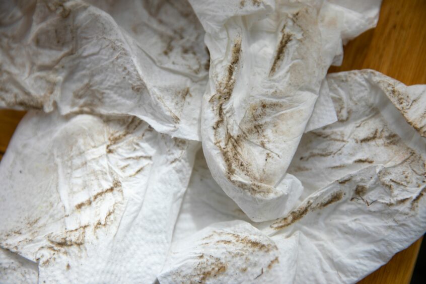 Brown dust on paper cloths. 