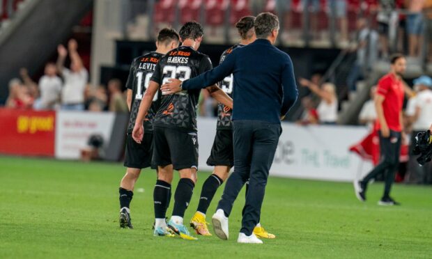 Dejected Dundee United stars walk off the pitch with manager Jack Ross at full-time in Alkmaar.