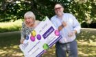 NHS worker Maxine Lloyd and her fiance Wayne Tilbury, from Kettering, celebrate her £1 million win on one of the National Lottery's instant win games at Barton Hall Hotel in Kettering, Northamptonshire, which became a double-celebration when she received the all-clear for breast cancer a few days later. Picture via PA.