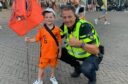 Dundee United fan Lucas Lowdon, 6, with one of the police officers.