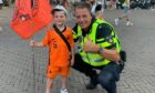 Dundee United fan Lucas Lowdon, 6, with one of the police officers.