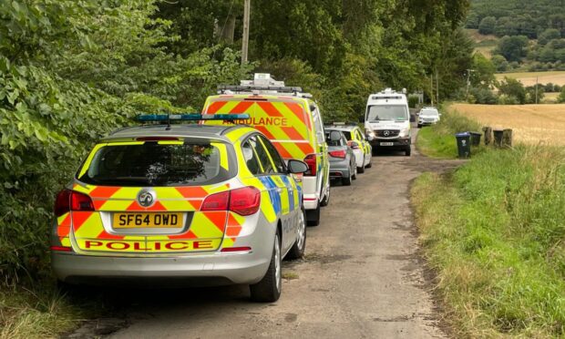 Police vehicles and an ambulance attending the incident near Forgandenny.