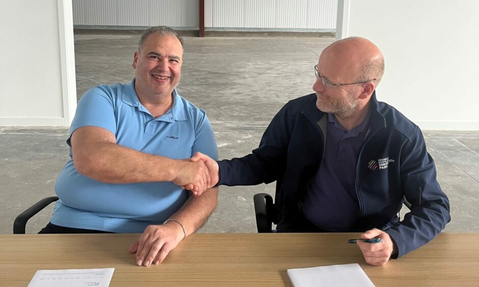 Golf buggy firm owner Giorgio signs the lease with MSIP business development manager Colin McIlraith in Dundee.