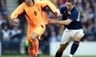 Lee Wilkie gets to grips with Ruud van Nistelrooy as Scotland took on the Netherlands in 2003.