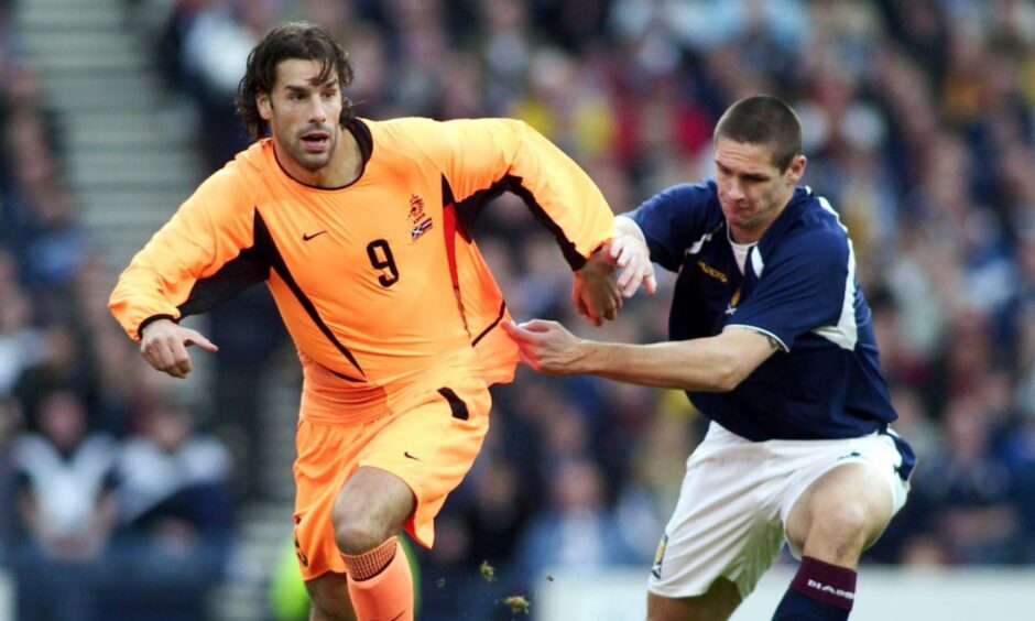 Lee Wilkie gets to grips with Ruud van Nistelrooy as Scotland took on the Netherlands in 2003