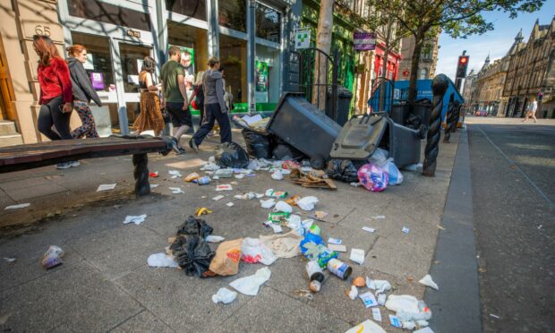 Residents and business owners in Dundee have spoken out about the mess of piling rubbish in the city centre amid the bin strikes.