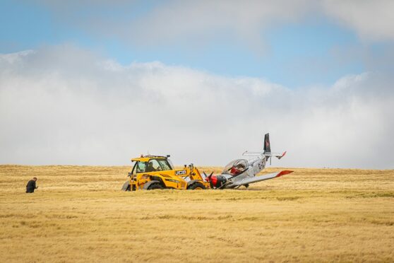 The plane being recovered by a nearby farmer after it crashed near Kinglassie.