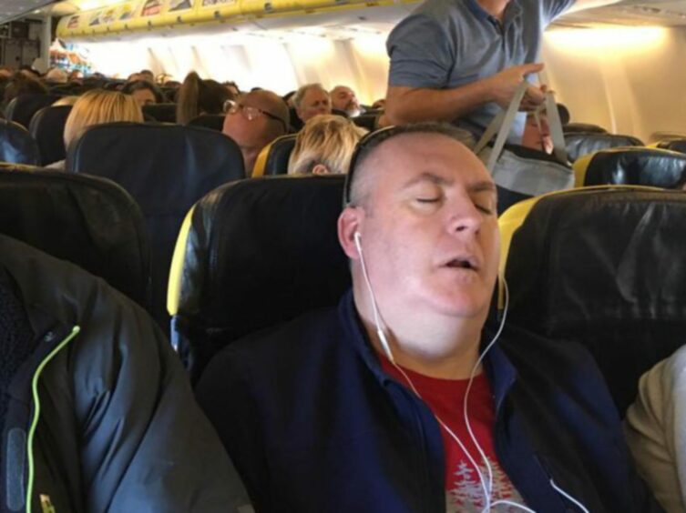 Steven asleep on a plane.
