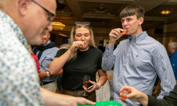 Brand ambassador Andy Marks hands out samples of cocktails to Annie Lyll and Jack Young from Dundee at the event. Pictures by Steve Brown/DCT Media.