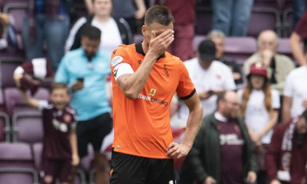 Dundee United skipper Ryan Edwards cuts a dejected figure at Tynecastle.