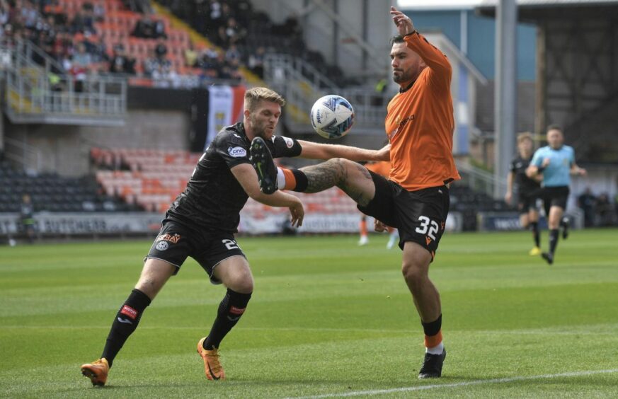 Marcus Fraser battles with Tony Watt at Tannadice.