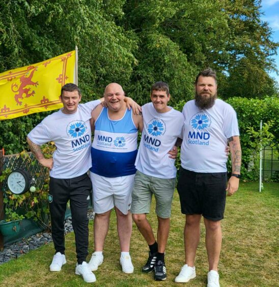 Steven Pert with his three sons in MND Scotland t-shirts.