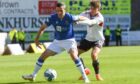 Jamie Murphy shields the ball under pressure from an Aberdeen attacker