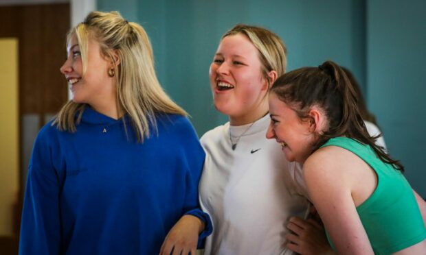 The Courier, CR0037387, News, Sheanne Mulholland story, Dundee schools musical society are rehearsing for their first show since lockdown. Picture shows; Sophie Roden, 17, (middle) who plays the leading female 'Sarah' with other cast members. Tuesday 9th August, 2022. Mhairi Edwards/DCT Media