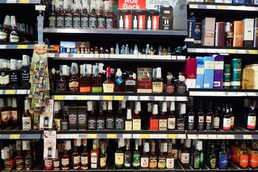 Shelves of alcohol for sale in a supermarket.