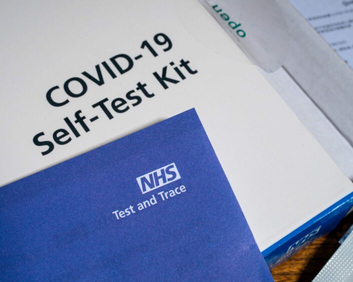 A Covid-19 self-test kit. The number of people testing positive for Covid in Scotland is estimated to be 104,400.