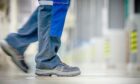 Factory worker wearing safety trainers