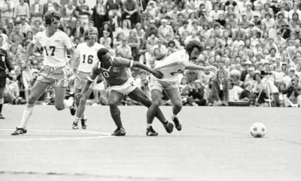 Jocky Scott (right) gets the better of Brazil legend Pele as Seattle Sounders took on New York Cosmos.