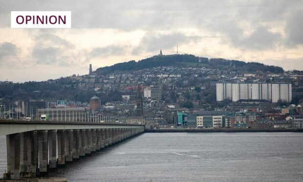 Dundee city from afar with a bridge in the foreground.