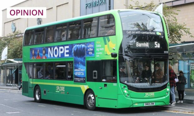 A green bus labelled 'Barnhill' stopped in Dundee.