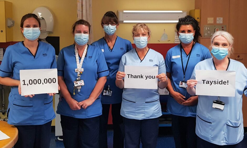 Nurses holding up signs stating: 1,000,000 Thank you Tayside