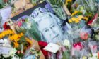 Flower tributes placed outside Buckingham Palace after Queen Elizabeth's death.
