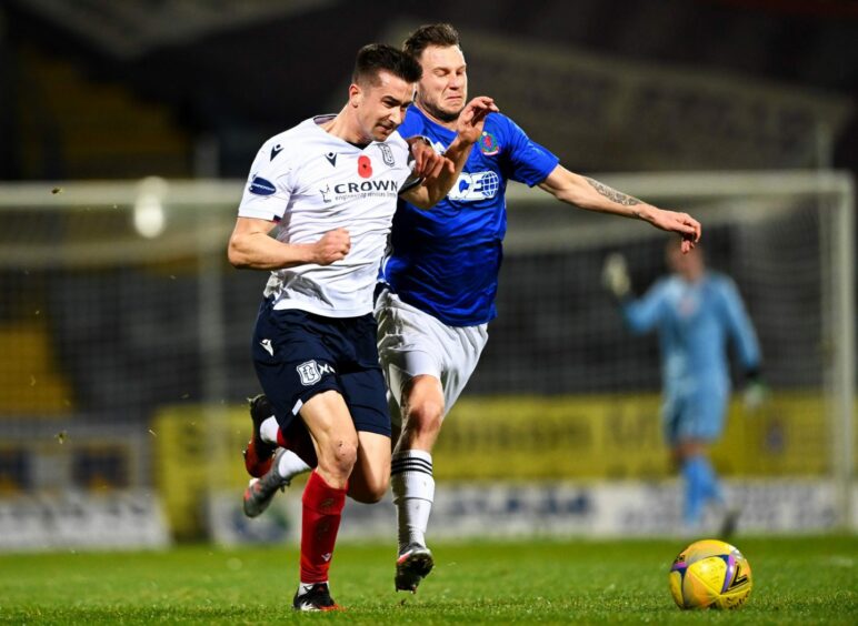 Cammy Kerr and Mitch Megginson tussle in Dundee and Cove's last encounter.