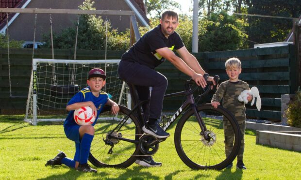 Craig Robertson with sons Ellis,11, and five-year-old Callan. Pic: Paul Reid.