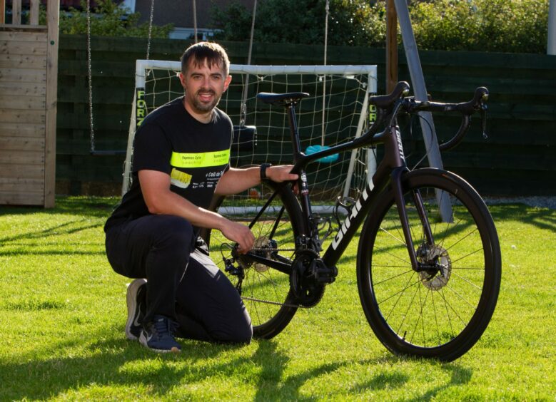 Craig Robertson of Arbroath is cycling round Scotland's Championship stadiums.