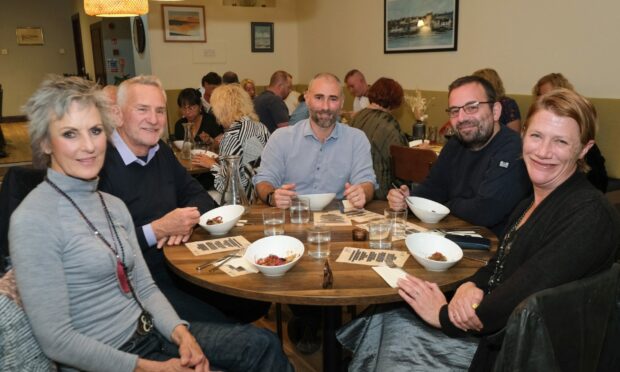 Guests enjoying one of the many dishes they were treated to on the night. Picture credit: Paul Reid.