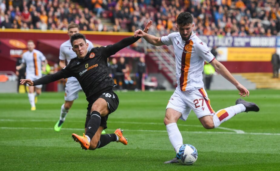Dundee United's Jamie McGrath put his body on the line to stop a shot against Motherwell.