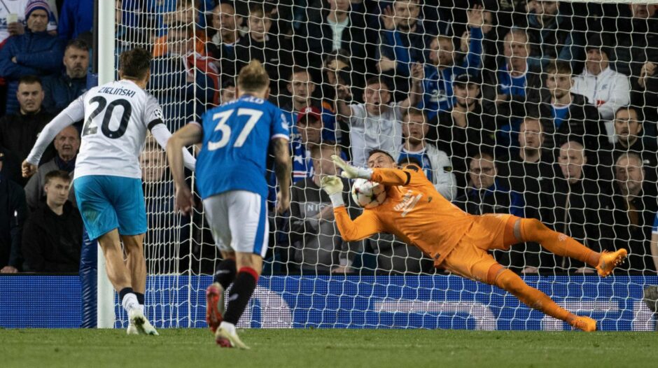 Rangers stopper Allan McGregor denies Napoli's Piotr Zielinski from the spot.