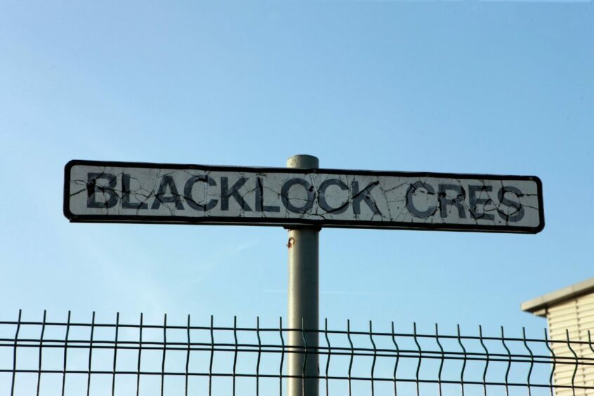 A sign reading Blacklock Cres