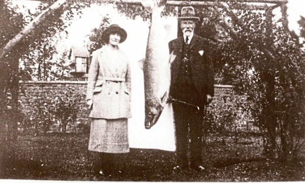 Georgina Ballantine and her father in October 1922 with her record-breaking 64lb salmon.