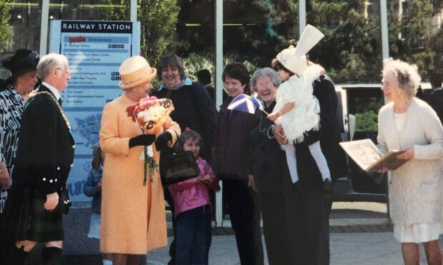 Aishah, now 22, had a special moment with the Queen in 2002.