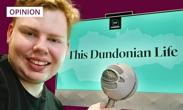 photo shows Andrew Batchelor with a microphone, in front of a computer screen with the words This Dundonian Life written on it.