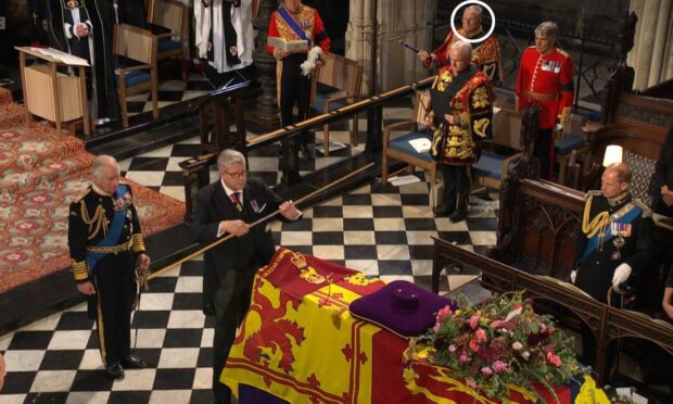 Dr Joseph Morrow (circled) watches as King Charles III and Lord Chamberlain perform their duties at the Queen's committal service at St George's Chapel, Windsor. Image: BBC.