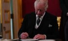 King Charles III signs an oath to uphold the security of the Church in Scotland during the Accession Council at St James's Palace, London, where King Charles III is formally proclaimed monarch.