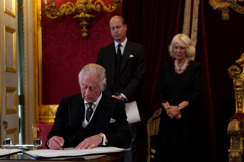 King Charles III signs an oath to uphold the security of the Church in Scotland during the Accession Council at St James's Palace, London.