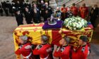 The Queen's coffin being taken into Westminster Hall, where she is lying in state before the funeral. Image: Oli Scarff/PA Wire