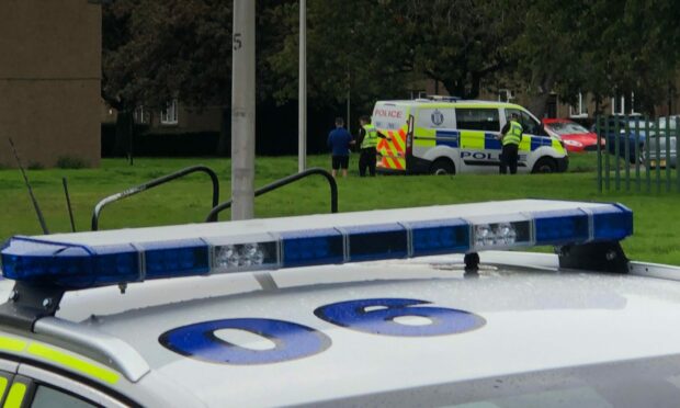 A man being led away from the incident on Cullen Place, Dundee.