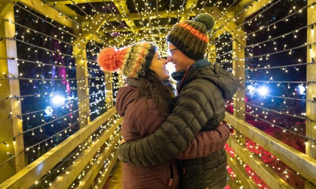 A couple take in the magic of a lit-up bridge in the Enchanted Forest. Image: Enchanted Forest