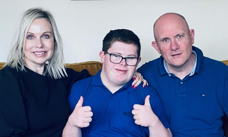 Aaron (centre) with his mother Lorraine and father Andy Ferguson.
