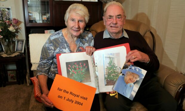 Les and Mary Craib with their diamond wedding card and memories of the Forfar Royal visit in 2004.
