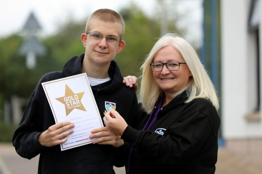 Robert Healey with his Courier Gold Star and teacher Olive Wainwright, who nominated him for the award.