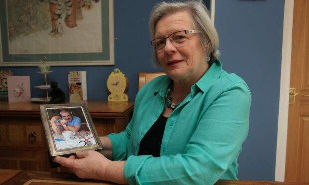 Joy Milne with a picture of her late husband Les.
