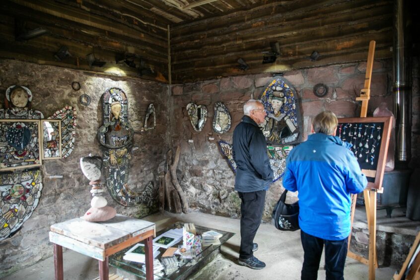 Visitors view the bothy art exhibition.