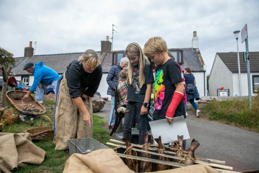 Young visitors learn how smokies are made.at the HAAR weekend at Auchmithie