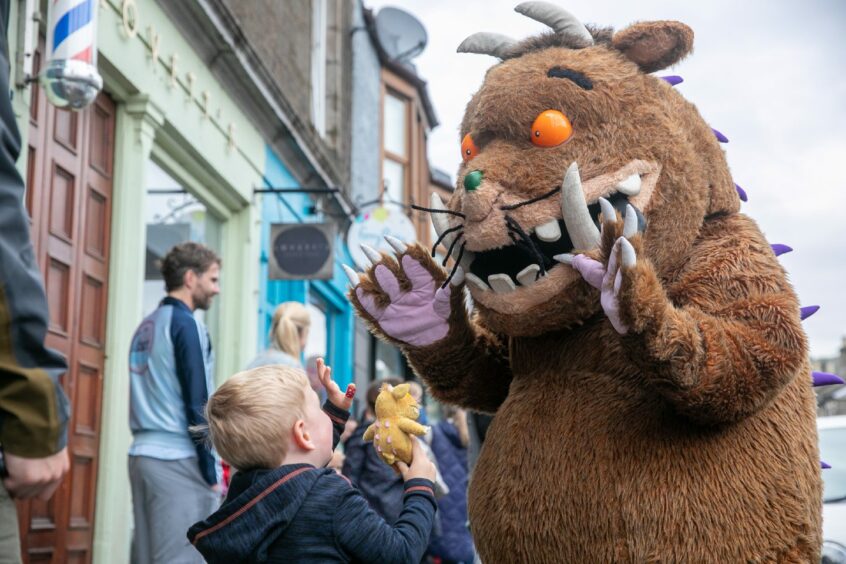 Sam Dunn, three, shows the Gruffalo his toy Gruffalo outside The Bookhouse on Gray Street, Broughty Ferry.