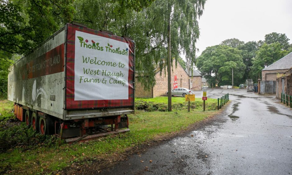 A lorry container parked at the entrance of a farm with a banner reading Welcome to West Haugh Farm and Camp.
